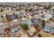 An aerial shot of a neighborhood displays orderly homes complemented by green spaces and mature trees at 18338 E Powers Pl, Centennial, CO 80015