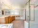 Bathroom with large vanity with double sinks and walk-in shower, plus a tub at 18338 E Powers Pl, Centennial, CO 80015