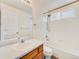 Bright bathroom featuring a tub and shower with a tiled surround and vanity with ample counter space at 18338 E Powers Pl, Centennial, CO 80015
