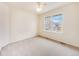 Bright bedroom with large window and neutral carpeting at 18338 E Powers Pl, Centennial, CO 80015