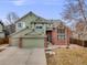 Charming two-story home with brick accents, a two-car garage, and manicured landscaping at 18338 E Powers Pl, Centennial, CO 80015
