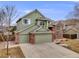 Charming two-story home with brick accents, a two-car garage, and manicured landscaping at 18338 E Powers Pl, Centennial, CO 80015