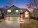 Charming two-story home with brick accents, a two-car garage, and manicured landscaping at 18338 E Powers Pl, Centennial, CO 80015