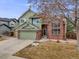Charming two-story home with brick accents, a two-car garage, and manicured landscaping at 18338 E Powers Pl, Centennial, CO 80015