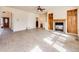 Open living room boasts tile floors, a fireplace, and built-in shelving for storage and décor at 18338 E Powers Pl, Centennial, CO 80015