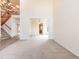 Open-concept living space featuring a staircase, views of the kitchen, and neutral decor at 18338 E Powers Pl, Centennial, CO 80015