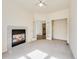 Inviting living room featuring a fireplace and French doors to the hallway and closet at 18338 E Powers Pl, Centennial, CO 80015