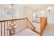 Elegant staircase with decorative lighting, natural wood banister, and bright, airy landing at 18338 E Powers Pl, Centennial, CO 80015