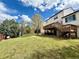 Expansive backyard with deck and trees, perfect for outdoor activities and relaxation at 18145 E Weaver Ave, Aurora, CO 80016