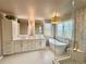 This primary bathroom features dual sinks, a soaking tub next to the large glass enclosed shower at 18145 E Weaver Ave, Aurora, CO 80016