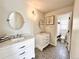 Modern bathroom with decorative floor tile, double sink vanity, and a toilet and tub shower combo in the next room at 18145 E Weaver Ave, Aurora, CO 80016