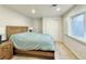 Bright bedroom boasts a large window and closet space, offering comfort and convenience at 18145 E Weaver Ave, Aurora, CO 80016