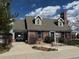 Charming brick clubhouse featuring dormer windows, a brick chimney, and well-maintained landscaping at 18145 E Weaver Ave, Aurora, CO 80016