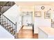 Inviting foyer with hardwood floors, staircase, and chandelier, creating a warm entrance to the home at 18145 E Weaver Ave, Aurora, CO 80016
