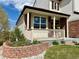 Charming front porch with brick accents and manicured landscaping at 18145 E Weaver Ave, Aurora, CO 80016