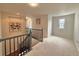 Upstairs hallway featuring carpet, railing, and plenty of natural light, providing a bright open space at 18145 E Weaver Ave, Aurora, CO 80016