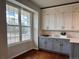Bright kitchen featuring stainless steel appliances, white and gray cabinets, and large window at 18145 E Weaver Ave, Aurora, CO 80016