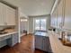 Bright kitchen with island desk space leading into the entryway at 18145 E Weaver Ave, Aurora, CO 80016