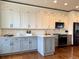 Well-lit kitchen featuring stainless steel appliances, sleek white and gray cabinets, and modern backsplash at 18145 E Weaver Ave, Aurora, CO 80016