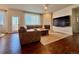 Living room with hardwood floors, stone fireplace, comfortable furniture, and backyard access at 18145 E Weaver Ave, Aurora, CO 80016