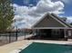 A fenced pool area offering a peek at the pool with a pool cover, set against a backdrop of residences at 18145 E Weaver Ave, Aurora, CO 80016