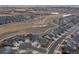 Aerial view of community featuring sidewalks, open spaces and pond at 20162 E 53Rd Pl, Denver, CO 80249