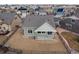 Aerial view of the home showcasing a well-manicured lawn, fenced backyard, and covered patio at 20162 E 53Rd Pl, Denver, CO 80249