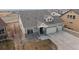 Aerial view of a home with three-car garage, stone accents, and manicured landscaping at 20162 E 53Rd Pl, Denver, CO 80249