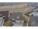 Aerial view of home with a three-car garage and fenced backyard overlooking an open space at 20162 E 53Rd Pl, Denver, CO 80249