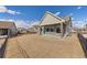 View of the back of the house with a covered patio and well-maintained lawn at 20162 E 53Rd Pl, Denver, CO 80249