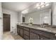 Primary bathroom with dual sinks, granite countertop and walk-in shower at 20162 E 53Rd Pl, Denver, CO 80249