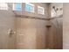 Tiled walk-in shower with modern fixtures, a glass door, and three built in upper windows for natural light at 20162 E 53Rd Pl, Denver, CO 80249
