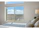 Bright bedroom showcasing a large window with scenic views, natural light, and neutral decor at 20162 E 53Rd Pl, Denver, CO 80249