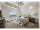 Spacious bedroom featuring a tray ceiling, plush carpeting, and lots of natural light from multiple windows at 20162 E 53Rd Pl, Denver, CO 80249