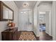 Entryway featuring a dark wood floor, a decorative mirror, and a view into the adjacent office at 20162 E 53Rd Pl, Denver, CO 80249