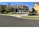 Traditional home featuring a manicured lawn, a three-car garage, and a stone and siding facade, for sale at 20162 E 53Rd Pl, Denver, CO 80249