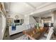 Open-concept living room and kitchen with hardwood floors, recessed lighting, and modern appliances at 20162 E 53Rd Pl, Denver, CO 80249