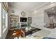 Open living room featuring a fireplace, stylish decor, dark hardwood floors, and a view into the foyer at 20162 E 53Rd Pl, Denver, CO 80249