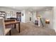 Upstairs office space featuring a desk, bookshelf and comfortable seating at 20162 E 53Rd Pl, Denver, CO 80249