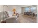 Upstairs space with chair and desk, illuminated by natural light from windows at 20162 E 53Rd Pl, Denver, CO 80249