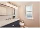 Charming bathroom features modern vanity, stylish mirror, and a frosted glass window for natural light at 7801 S Hill Dr, Littleton, CO 80120