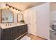 Stylish bathroom featuring double sinks, unique light fixtures, and modern grey cabinets at 7801 S Hill Dr, Littleton, CO 80120