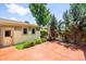 Cozy backyard patio with a stained concrete patio, mature trees, privacy fence, and convenient access to the house at 1934 S Sherman St, Denver, CO 80210