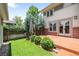 This backyard features a concrete patio, lawn, trees and partial fence with convenient walk-out access from the house at 1934 S Sherman St, Denver, CO 80210