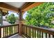 Charming balcony with wood railings and brick pillars, offering a serene outdoor space with lush views at 1934 S Sherman St, Denver, CO 80210