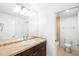 Bathroom featuring a tiled countertop, large mirror, and combination shower and bathtub at 1934 S Sherman St, Denver, CO 80210
