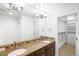 Elegant bathroom with double sinks, granite countertops, a walk-in closet, and updated lighting at 1934 S Sherman St, Denver, CO 80210