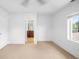 Bedroom view shows neutral carpet, white walls, and ensuite bathroom at 1934 S Sherman St, Denver, CO 80210