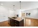 Open-concept kitchen with island, stainless steel dishwasher, and adjacent living area at 1934 S Sherman St, Denver, CO 80210