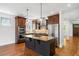 Spacious kitchen featuring an island with pendant lights, custom cabinetry and stainless steel appliances at 1934 S Sherman St, Denver, CO 80210